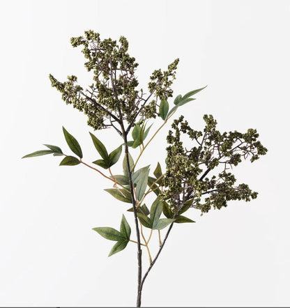 Artificial plant branch with green leaves and buds on a white background