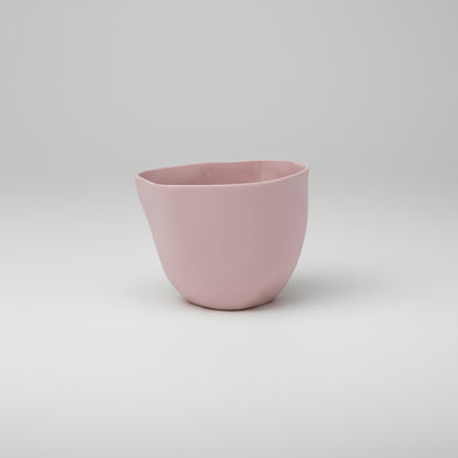 Pink ceramic cup on a white background