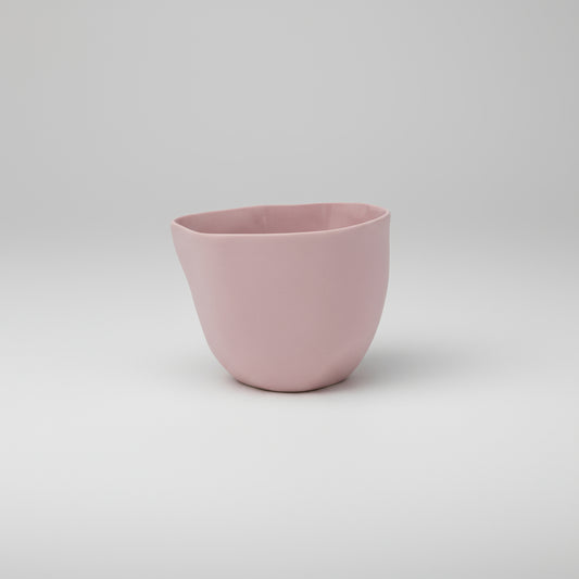 Pink ceramic cup on a white background