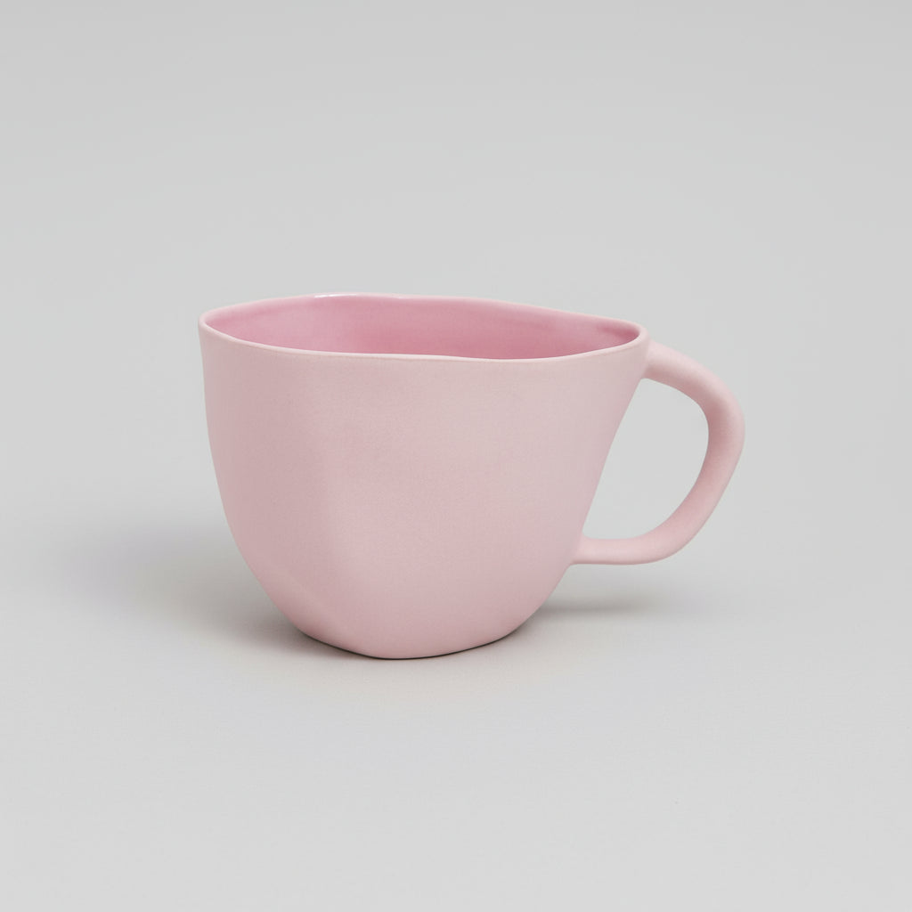 Pink mug on a white background