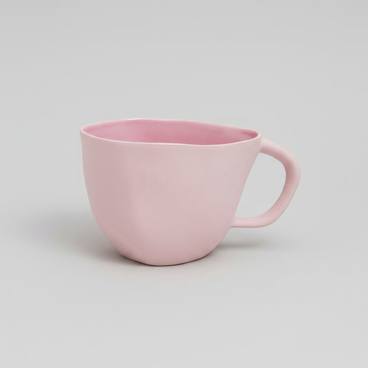 Pink mug on a white background