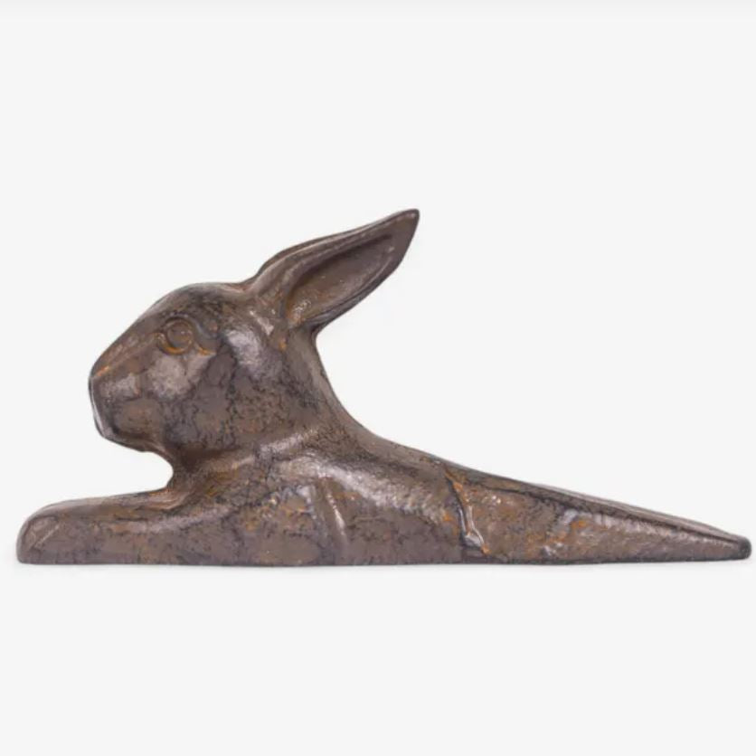 Bronze doorstop of a rabbit on a white background