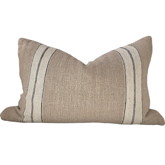 Beige pillow with black stripes on a white background