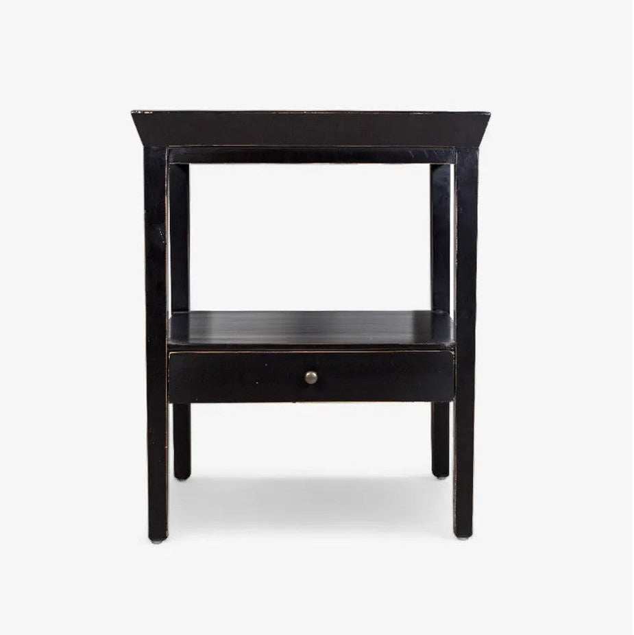 Black side table with a drawer on a white background