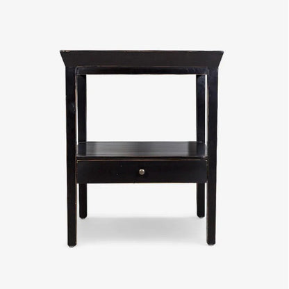 Black side table with a drawer on a white background