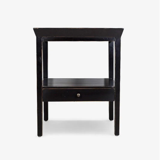 Black side table with a drawer on a white background