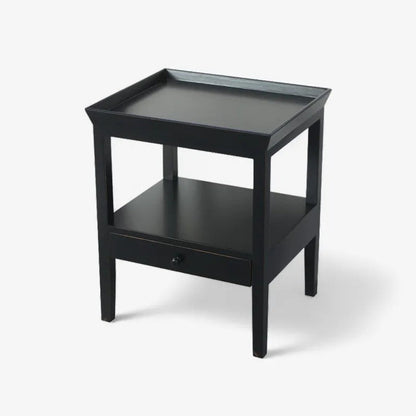 Black side table with a drawer on a white background