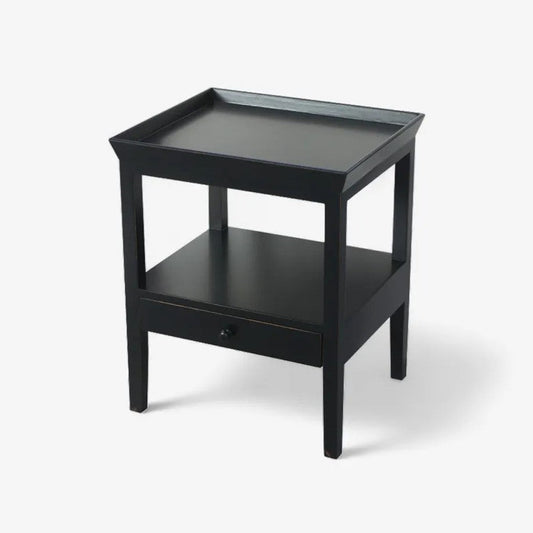 Black side table with a drawer on a white background