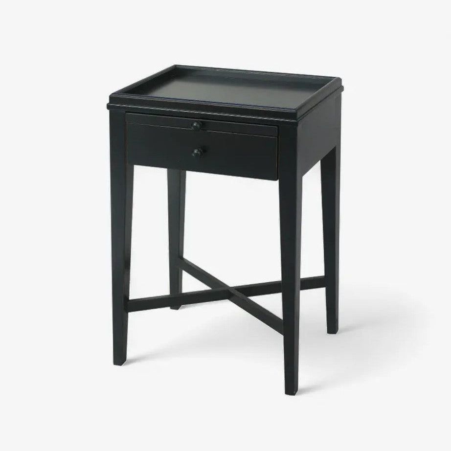 Black side table with a drawer on a white background