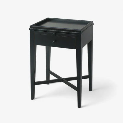 Black side table with a drawer on a white background