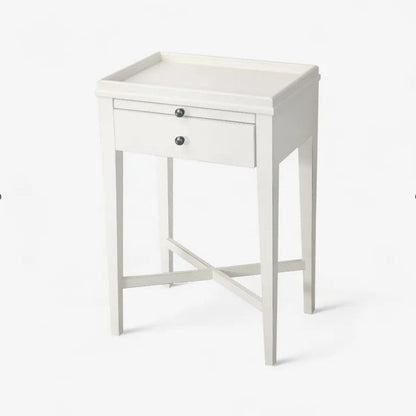 White side table with a drawer on a white background