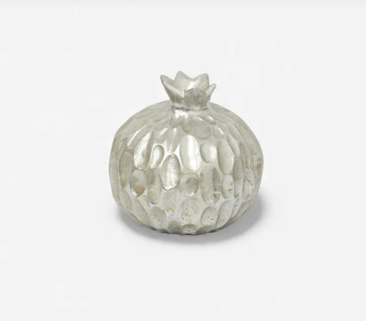 Silver textured fruit on a white background