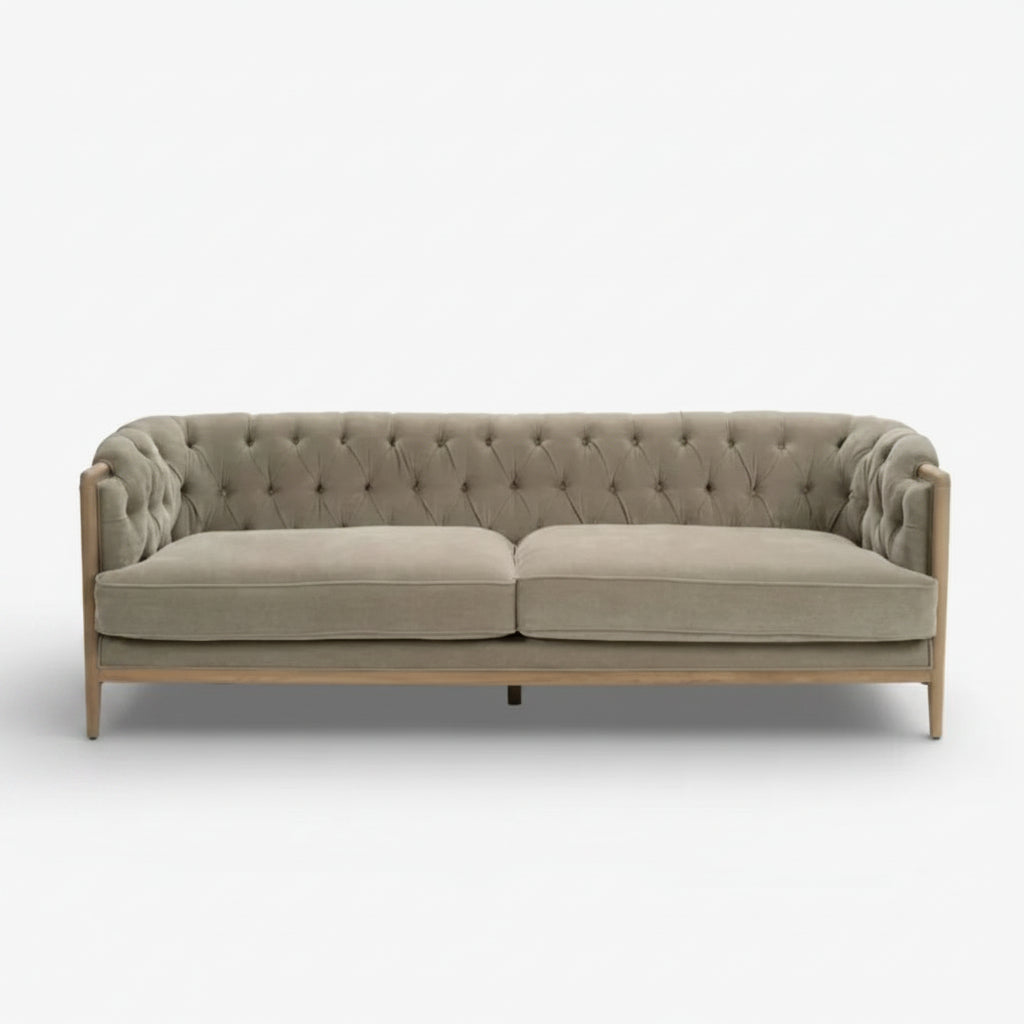 Gray tufted sofa on a white background