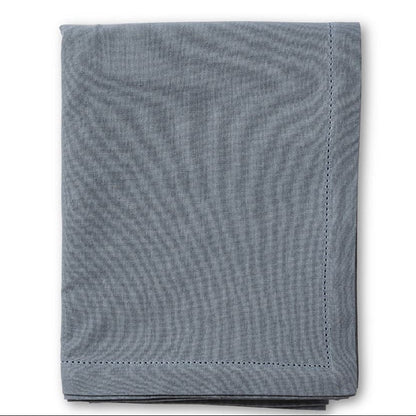 Folded blue textured fabric on a white background