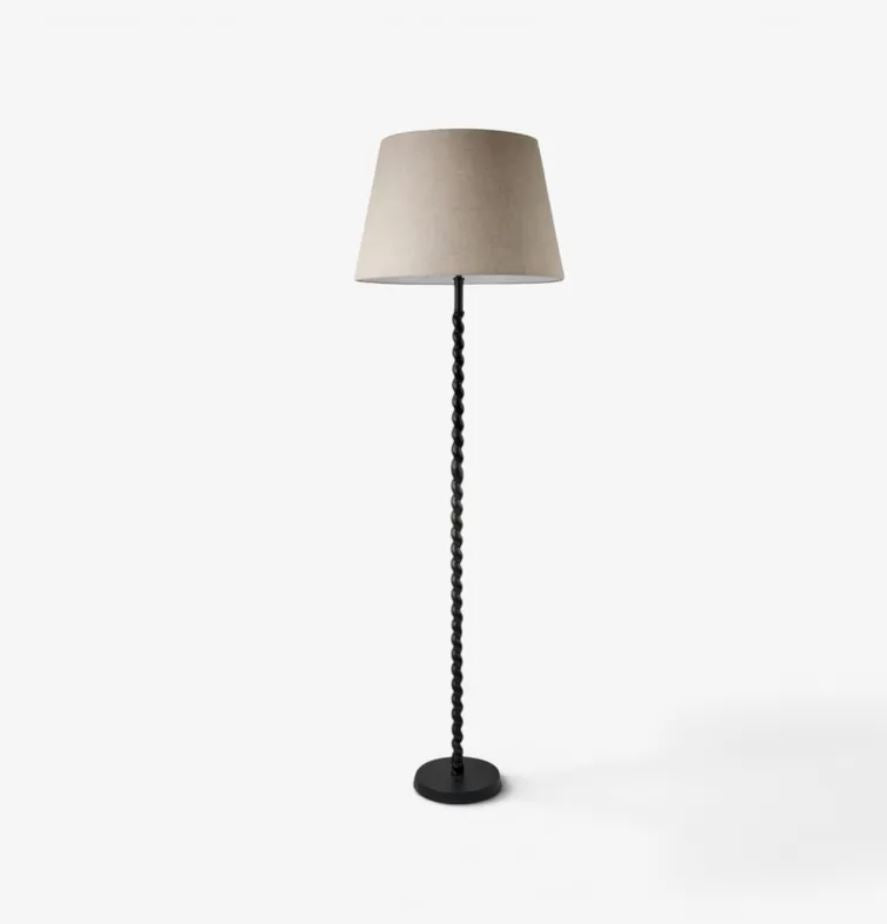 Floor lamp with a beige shade on a white background