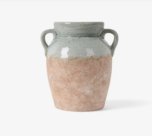 Ceramic vase with two handles on a white background