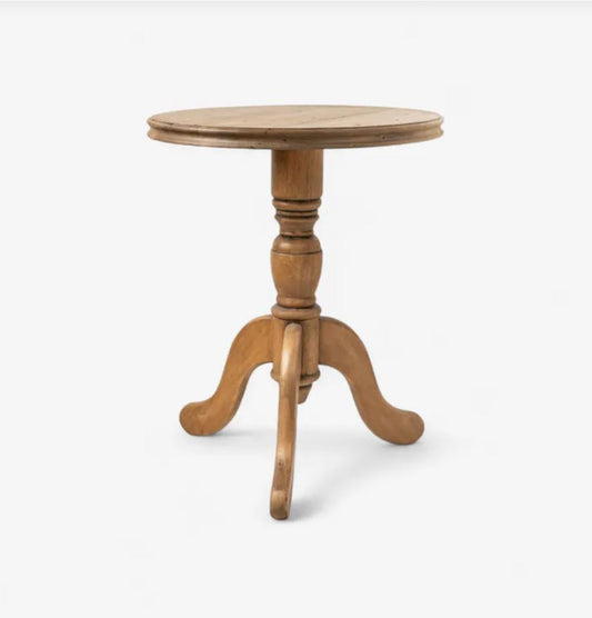 Wooden round table with a pedestal base on a white background