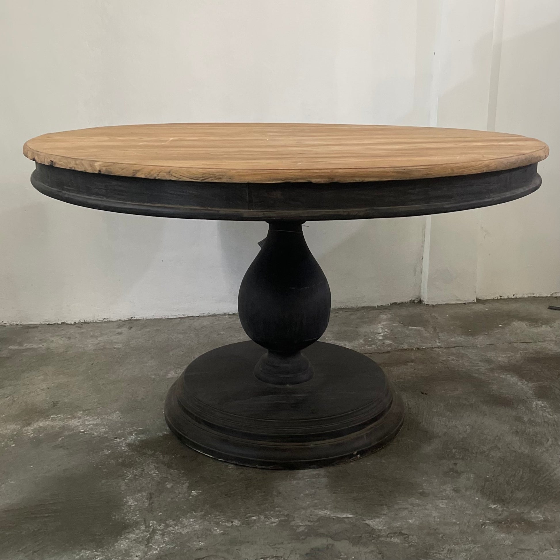 Our Remy Table is crafted from durable teak wood, boasting a round shape that is suitable for both indoor and outdoor use. Its unique carved leg design gives it a timeless, two-toned look that will elevate any space. With its solid construction and classic aesthetic, this round dining table is a perfect choice for those seeking a long-lasting elegant style. Front