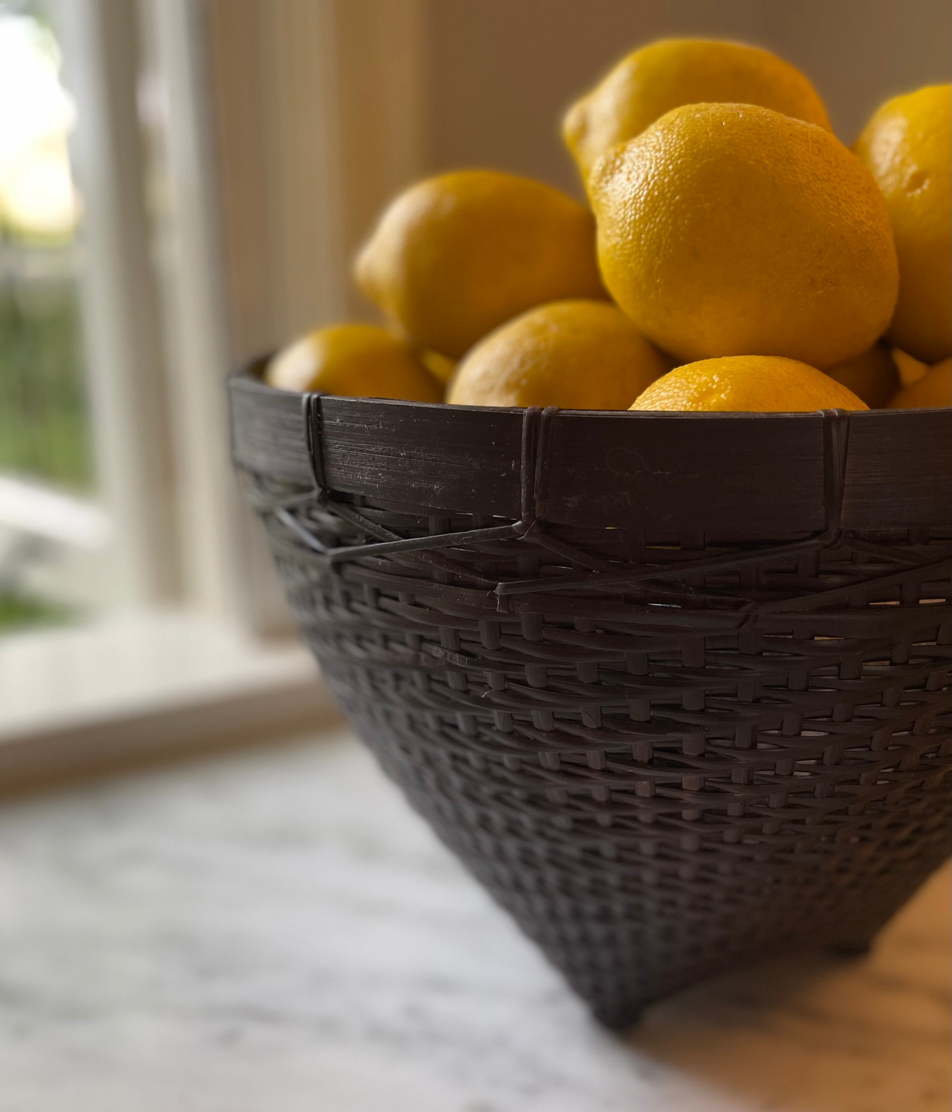 Our Banyu Handwoven Bamboo & Rattan Basket is crafted in East Indonesian Island Villages. These striking baskets can be used as an accent piece or to provide additional useful storage. Styled close up.