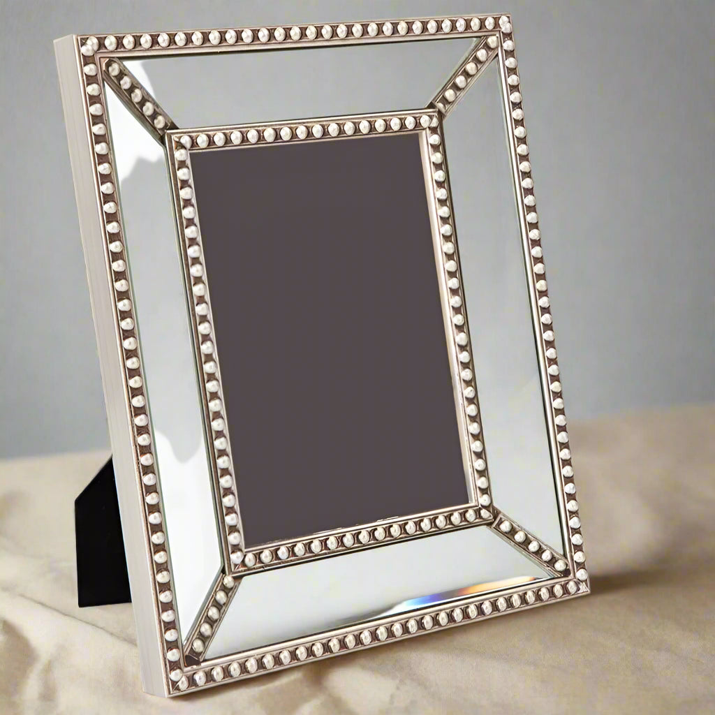 This classic mirrored frame with exquisite antique silver bead detailing is a great way to display your memories. The versatile design fits a 5 x 7” photo and can be positioned horizontally or vertically for ultimate versatility. Front