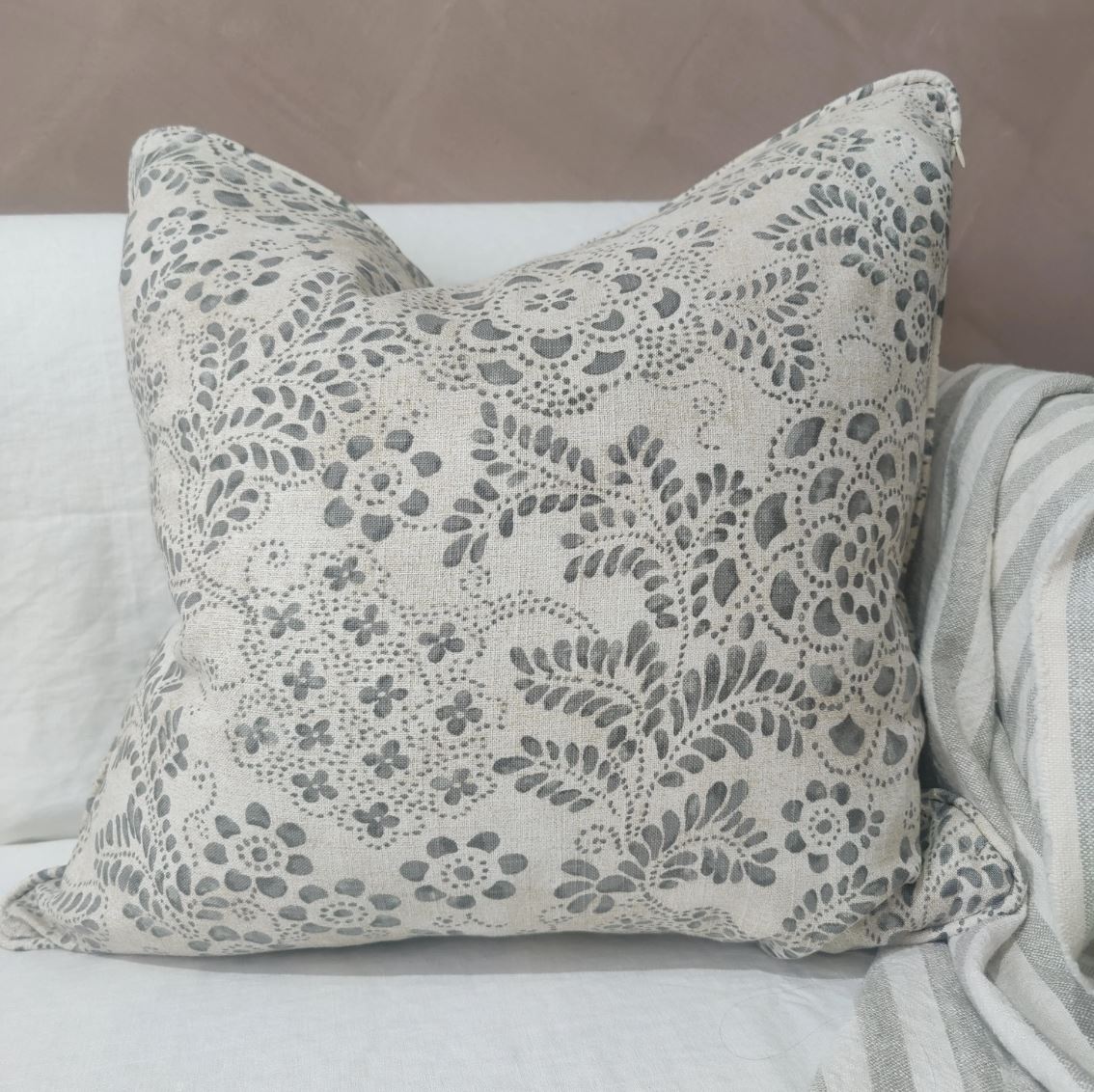 Effortlessly blend design and fabric with this stunning Foliage Taupe & Grey Linen Cushion. Made from a luxurious blend of 50% cotton and 50% linen, the invisible zipper adds a touch of elegance to its French-inspired style.