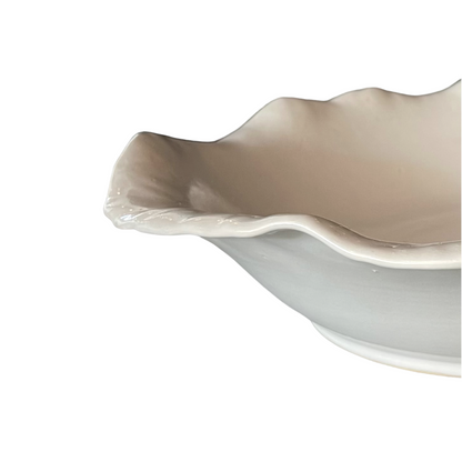 Our Handcrafted Glazed Cream Gemi Plate is a beautiful handmade piece, with tactile qualities that are evident in its organic shape and distinctive finish. The subtle cream stoneware brings a stylish aesthetic to your table. Detail.