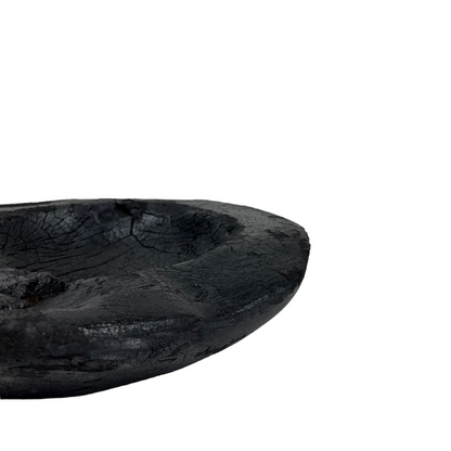 Indulge in the perfect combination of organic and airy design with our exquisite Handcarved Api Teak Burned Bowl. Crafted from the teak tree's root and expertly finished with a unique burning method, resulting in a striking deep black hue. Side