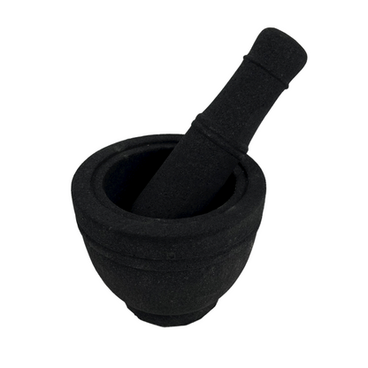 Volcanic rock mortars and pestles have been used by great cooks for thousands of years. Our Handcarved Jantung Volcanic Rock Mortar Pestle is created from a single piece of stone. In addition to being a great prep tool, it is an impressive serving dish for guacamole and other party favourites. Front.