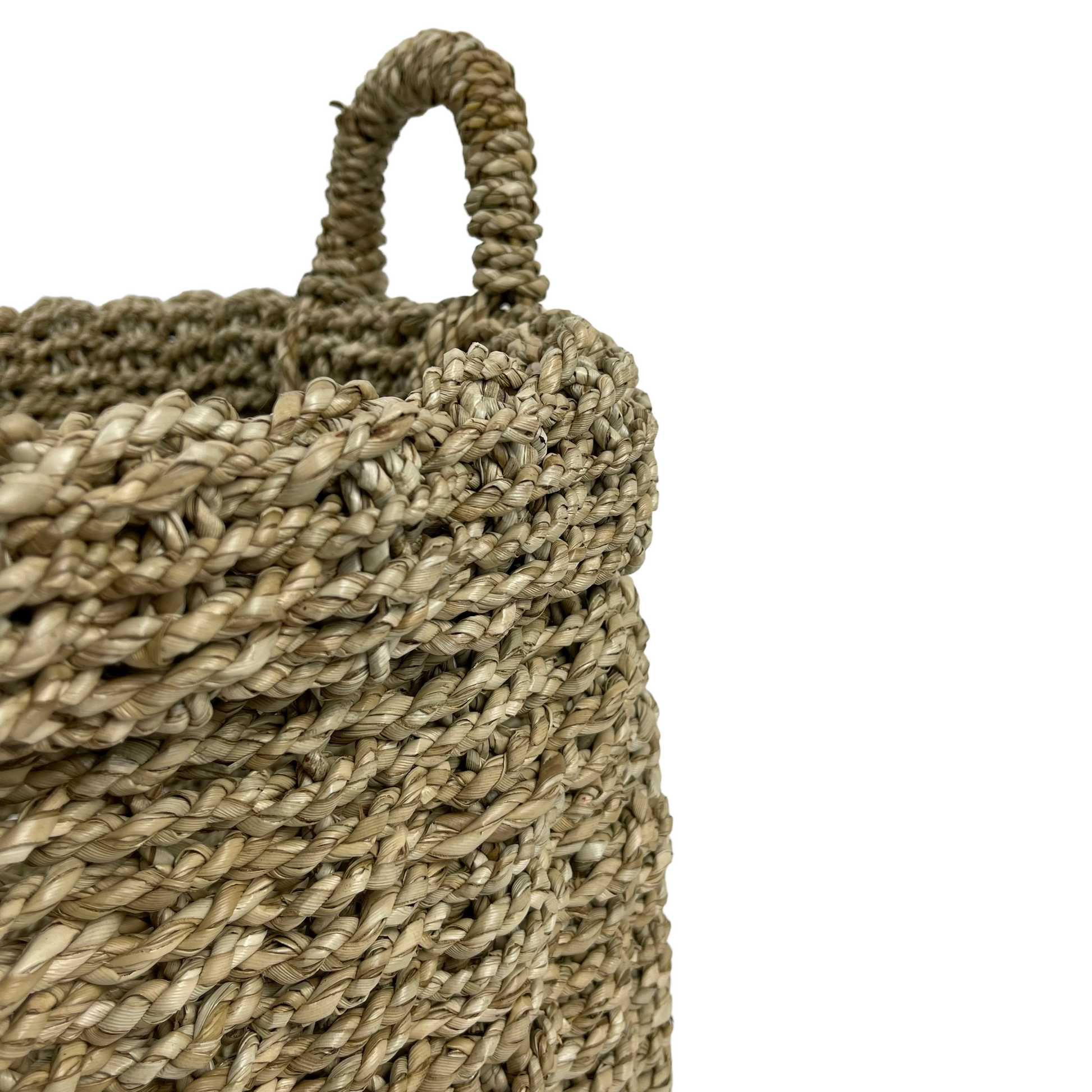 Tightly handwoven from seagrass, our Saudari Seagrass Baskets feature sturdy handles which add charm and understated style. Use to display indoor plants or for a wide range of storage options. Close up.