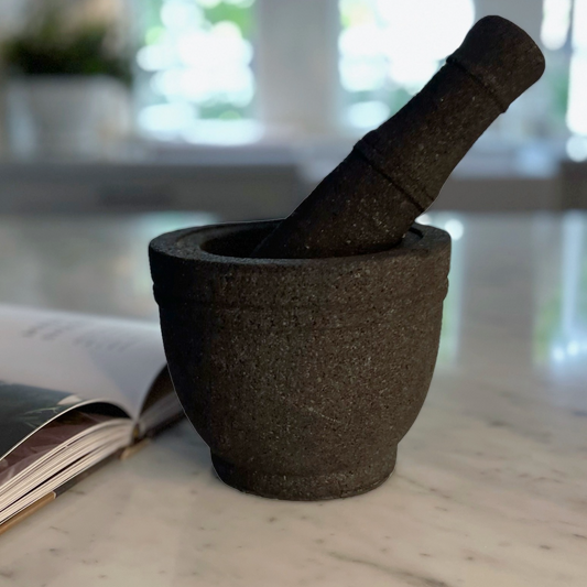 Volcanic rock mortars and pestles have been used by great cooks for thousands of years. Our Handcarved Jantung Volcanic Rock Mortar Pestle is created from a single piece of stone. In addition to being a great prep tool, it is an impressive serving dish for guacamole and other party favourites.