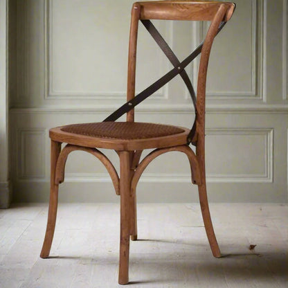 Fashioned with a sturdily crafted Oak frame and adorned with aged metal straps, the Lyon Crossback Chair features a rattan seat to enhance its visual aesthetic. Front