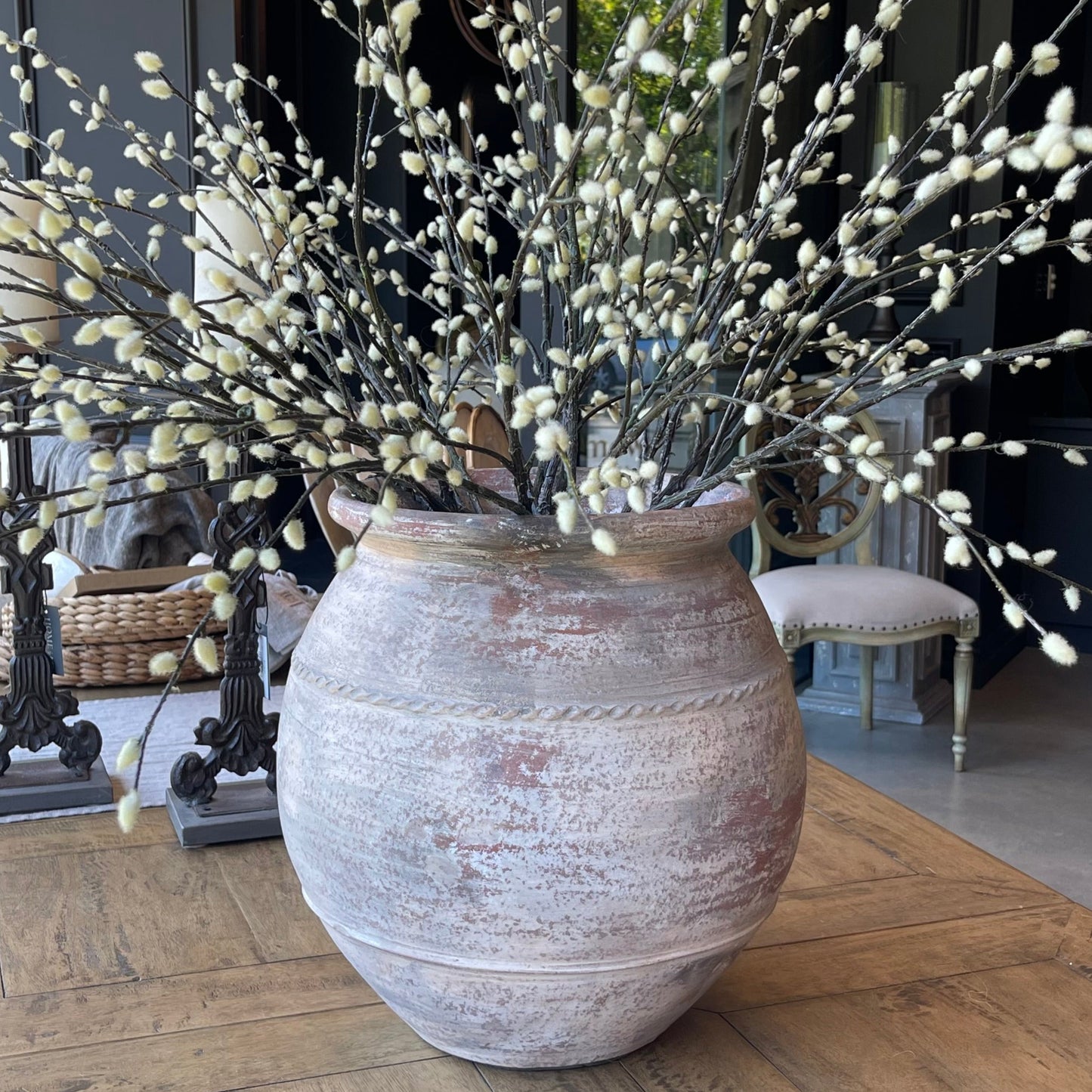 This Terracotta Pot boasts an impressive, aged exterior with attractive limewashed details that complement a variety of styles and spaces. Its generous size is ideal for both greenery and flowers, while the raised texture and rustic colors add a charming touch. Styled.