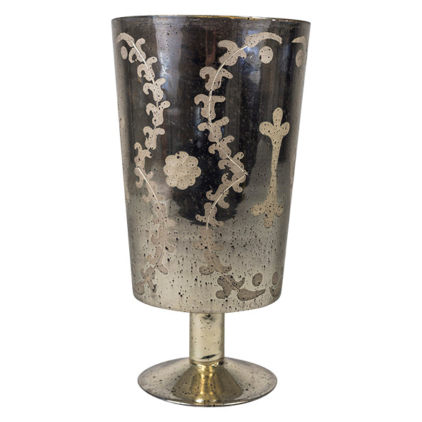 Experience the vintage-inspired charm of the Marcello Etched Mirrored Hurricane. With its elegant etched glass and mirrored silver finish, this hurricane is perfect for adding a touch of sophistication to any room. Whether displayed alone or in a pair, it's sure to bring warmth and ambiance with its ability to hold a single 3x4" candle. Illuminate your home in style with this stunning hurricane.