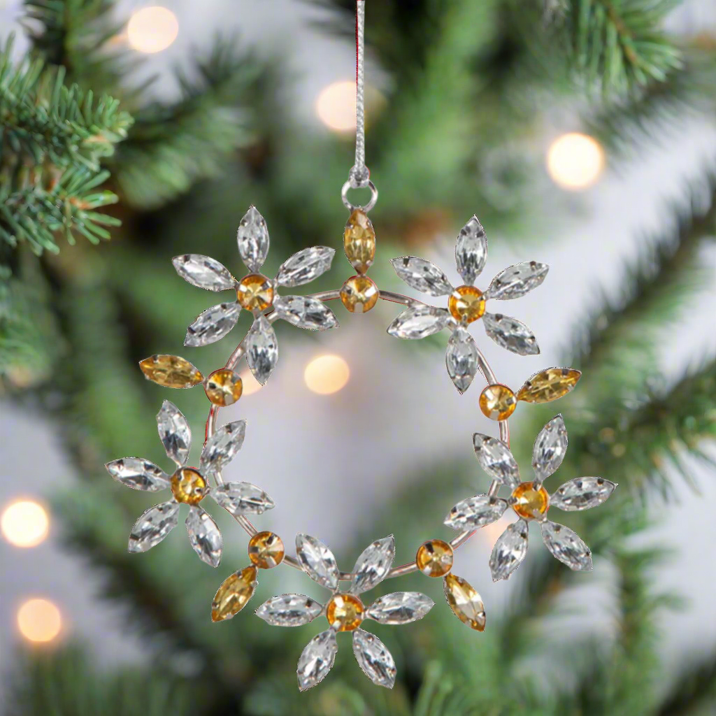 Add a touch of elegance to your tree with our stunning gold and silver snowflake ornament.