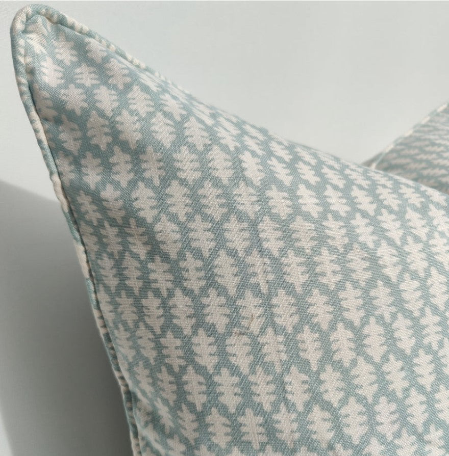 The exquisite and enchanting pattern of this luxurious Pale Forest Green Linen Cotton Cushion adds a touch of delicate charm to your pillow arrangements, set against a stunning backdrop of pale forest colours. Corner close up.