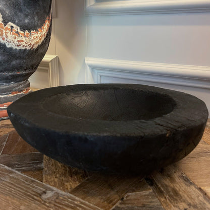 Indulge in the perfect combination of organic and airy design with our exquisite Handcarved Api Teak Burned Bowl. Crafted from the teak tree's root and expertly finished with a unique burning method, resulting in a striking deep black hue.