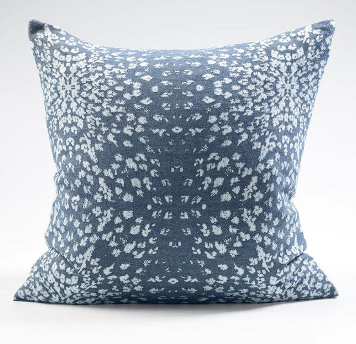 The Vail Blue &amp; White Reversible Cotton Cashmere Cushion features two distinct designs, one on a crisp white base, the other on navy blue. The cushion provides luxuriously soft comfort to your home while the Japanese flange ensures durability and a beautiful finish. Enjoy a winter-themed backdrop of snowflakes with this whimsical cushion.