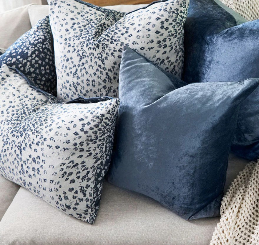 The Vail Blue &amp; White Reversible Cotton Cashmere Cushion features two distinct designs, one on a crisp white base, the other on navy blue. The cushion provides luxuriously soft comfort to your home while the Japanese flange ensures durability and a beautiful finish. Enjoy a winter-themed backdrop of snowflakes with this whimsical cushion. Styled.