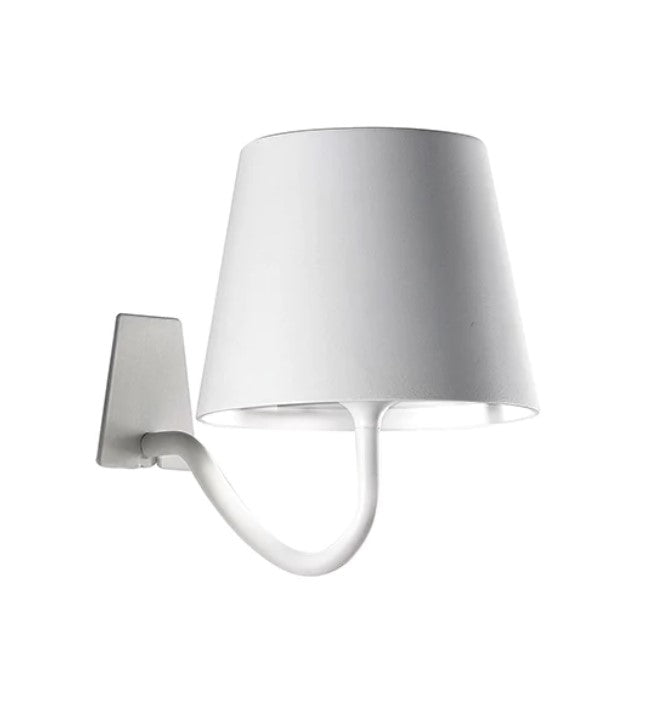 The Parete Wall Mounted Wall Lamp is a rechargeable wall sconce with a matte painted aluminium fixture, a polycarbonate diffuser and a LED light source. Battery life is guaranteed for more than 9 hours. Perfect for indoors if you don't have power where you need it or just simply don't want messy cords cluttering up your space. Also ideal for outdoors as Poldina has IP54 (water resistant) rating. Side