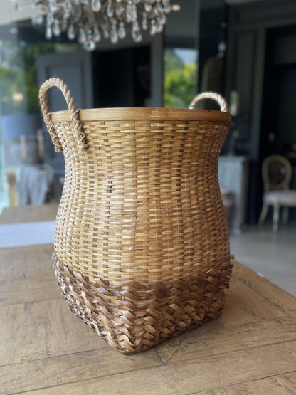 The attractive yet functional Fitri Handcrafted Bamboo Basket with handles is made in the South East Asia Islands in a design handed down from generation to generation. Styled front.