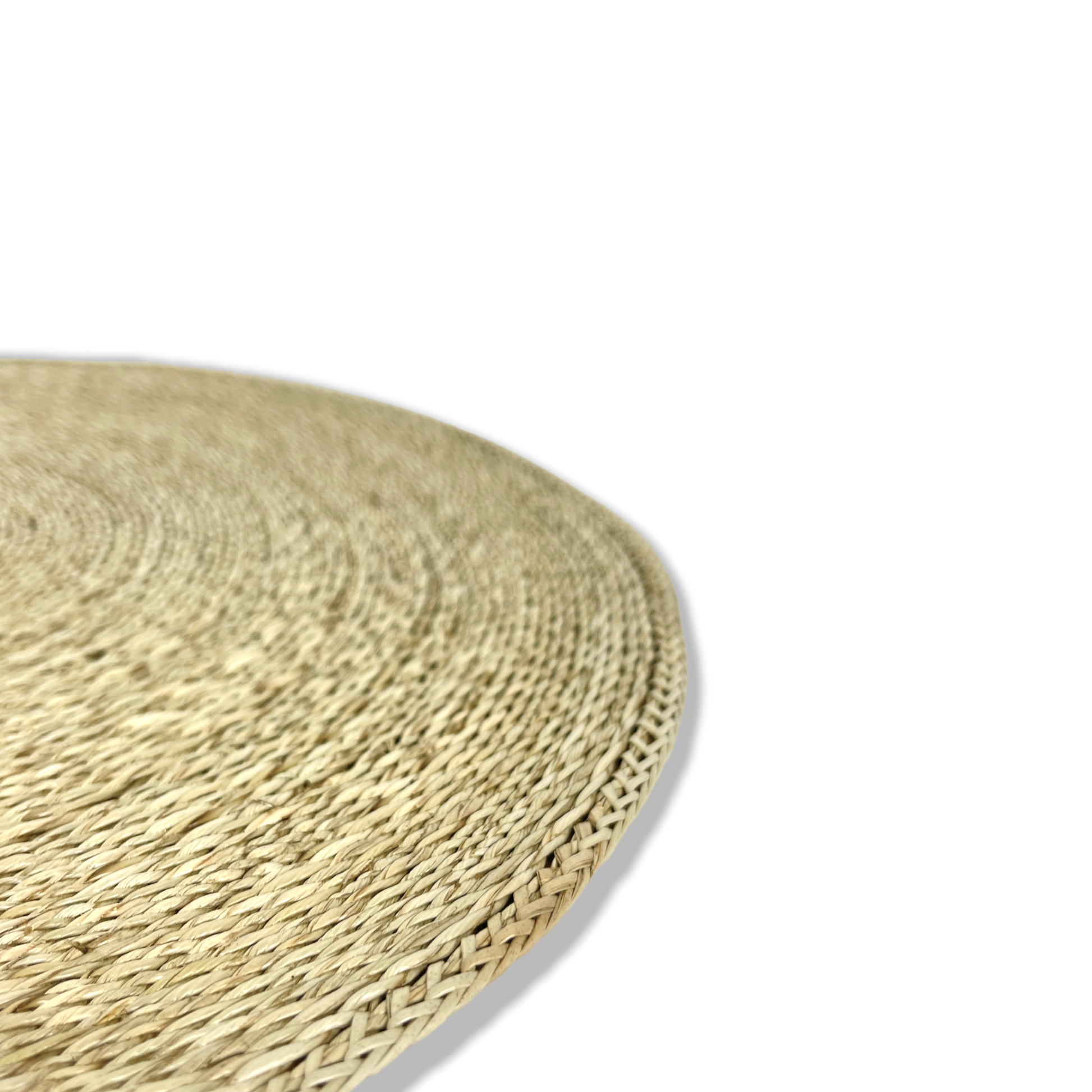 Our Handwoven Pandan Natural Round Placemat offer a great way to both decorate and protect your table. Corner close up.