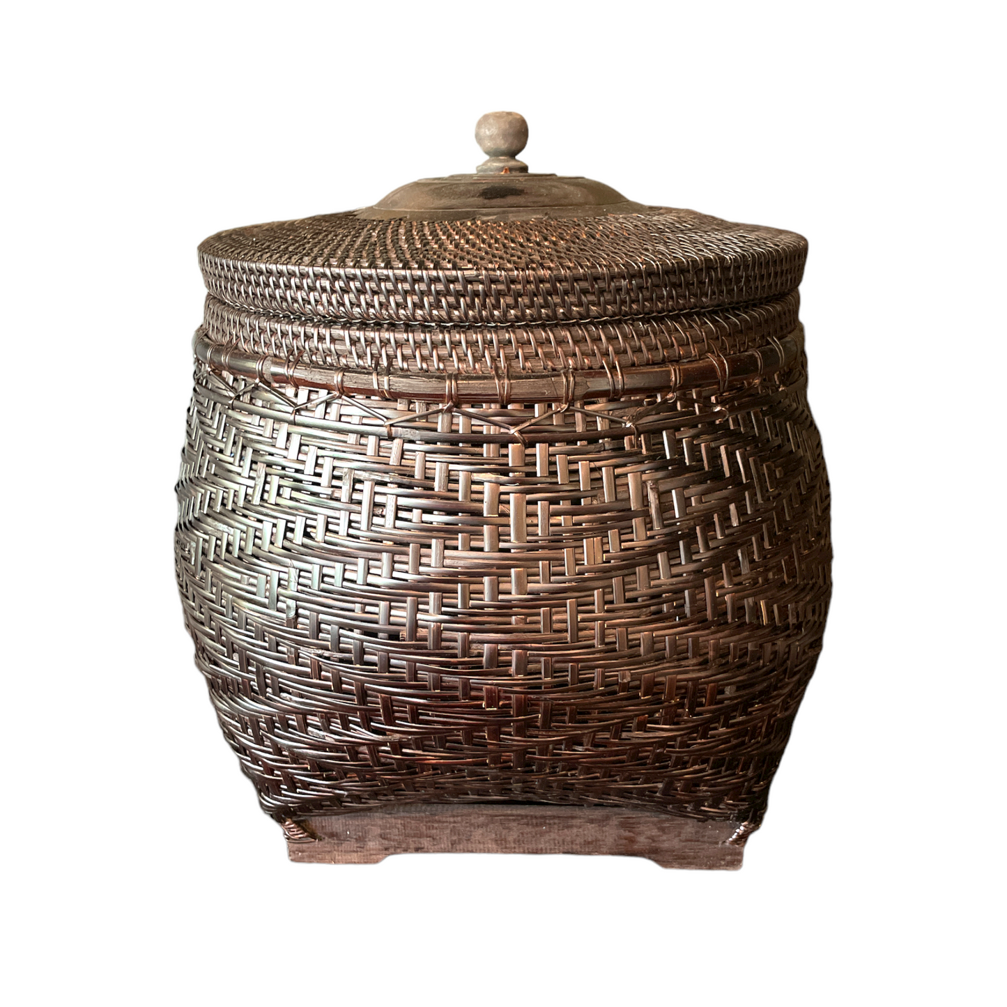 Crafted by skilled artisans from East Indonesian Island Villages using locally-sourced rattan and bamboo, the Cahyono Handmade Rattan & Bamboo Basket is visually stunning and exceptionally functional. Their deep, rich brown and black colour is complemented by a sturdy lid and wooden handle, making them the perfect choice for decorative accents or convenient storage solutions. Front.