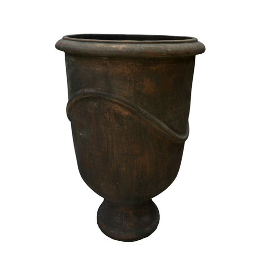 Indulge in the timeless design and rustic charm of this textured pot. Its classic shape and pared-back aesthetic give it a unique character that will enhance any space.