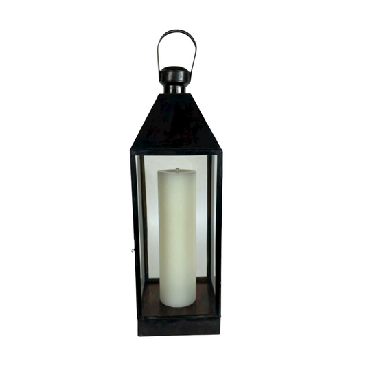 Stylishly decorate your living space with our stunning tall Singaraja Black Brass & Glass Lantern. The antique black brass metal finish perfectly complements the recycled glass panels and looks great styled with a candle. Front.