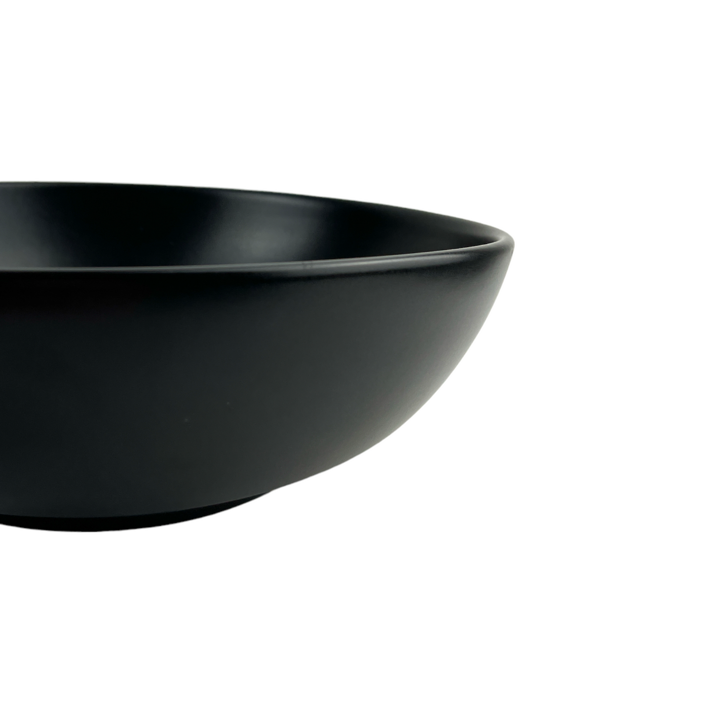 Experience the simplistic elegance of our Handcrafted Black Jenis Bowl, designed with a smooth and gentle edge for a touch of refinement. Detail.