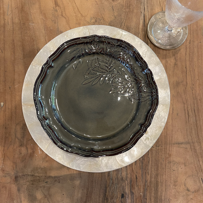 Indulge in the exquisite lustre of our Reversible Capiz Round Placemat, elevating your dining experience and captivating your guests with its undeniable appeal. Styled.