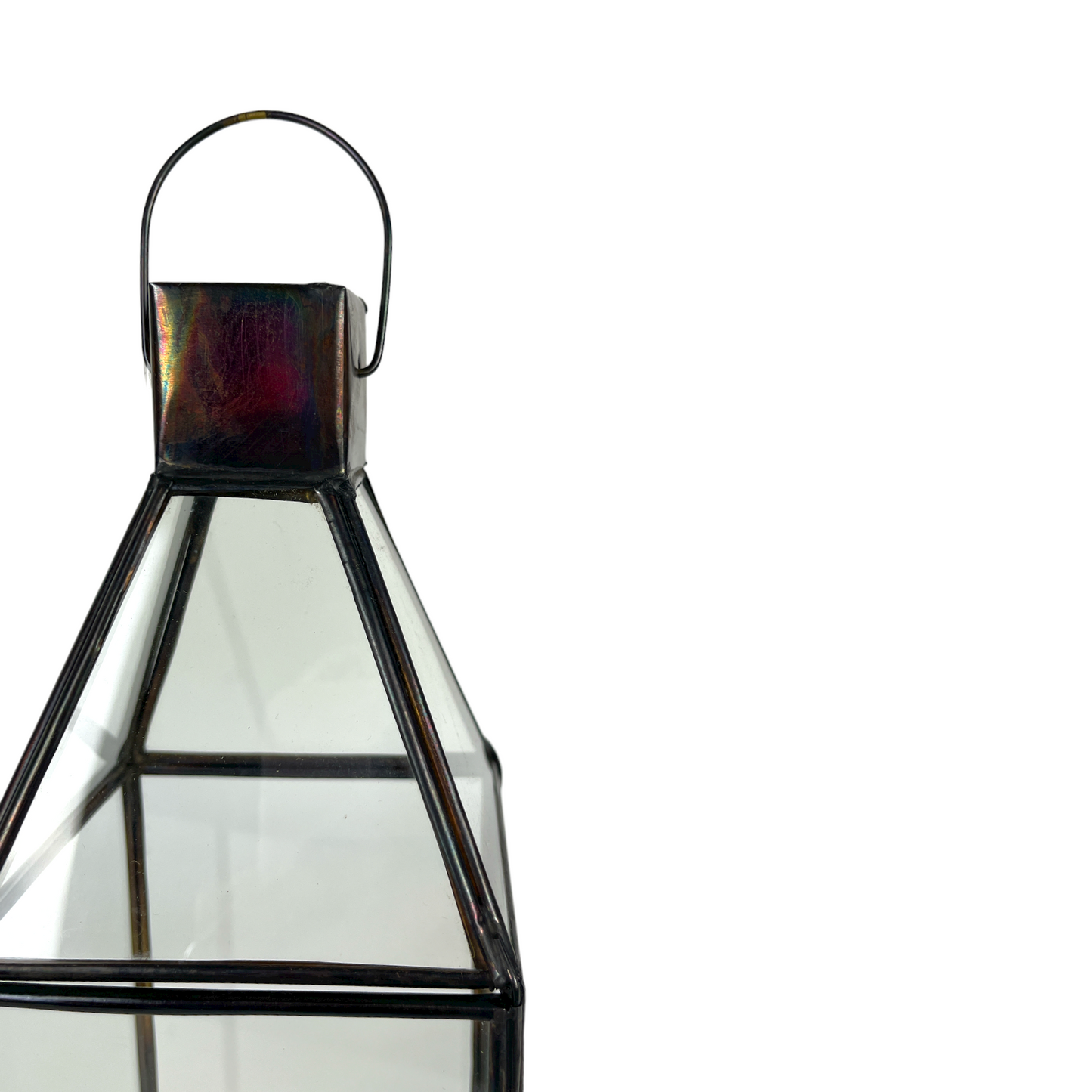 The Roro Brass & Glass Lantern is skilfully crafted from highly polished brass. The antique black metal finish perfectly complements the recycled glass panels. The lantern has a brass sheet base and simple carry handle. The glass door neatly opens with a simple pin fixing, allowing easy access to place a candle inside. Detail.