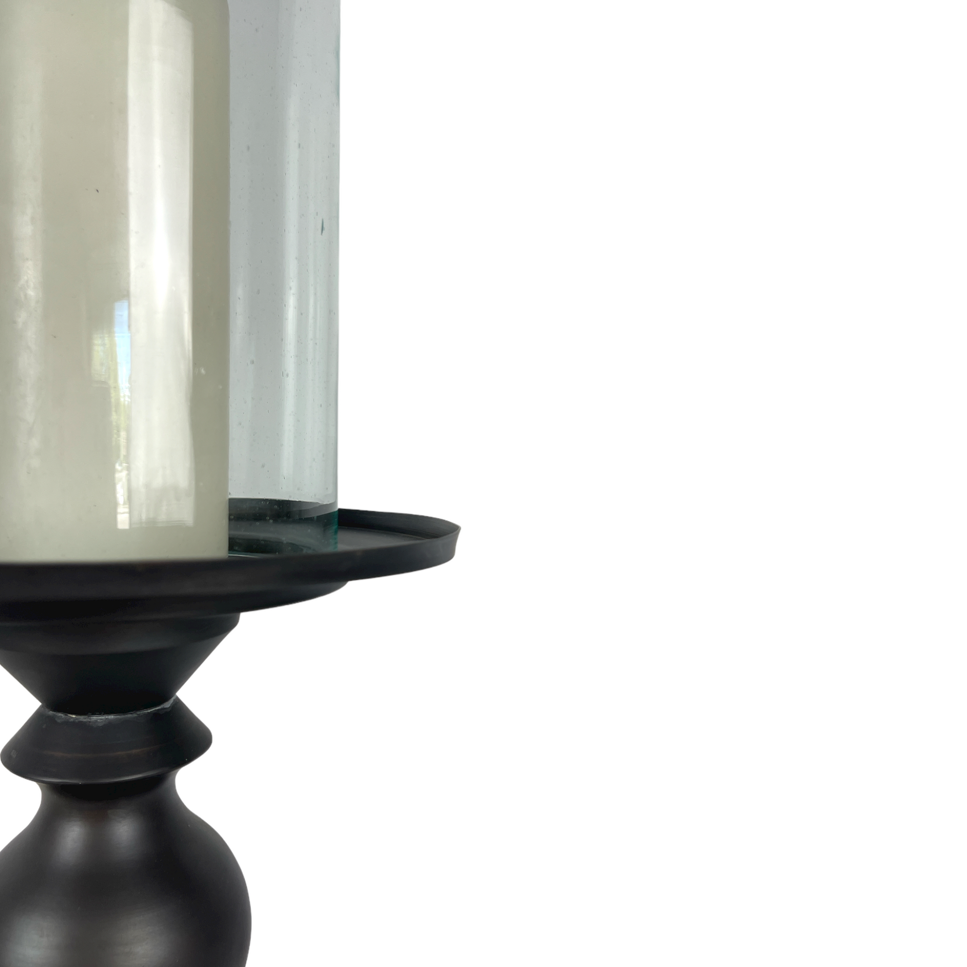 Crafted from bronzed copper, the elegant contours of our Rocca Copper Candle Holder has a refined elegant feel. The classic design displays a church pillar candle perfectly, creating a soft ambient aesthetic. Close up.